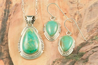 Genuine Crow Springs Turquoise set in Sterling Silver. Beautiful Pendant and Earring Set. Created by Navajo Artists John Nelson and Kathy Yazzie. Signed by the artists. The Crow Springs Mine is located near Tonopah, Nevada. Free 18